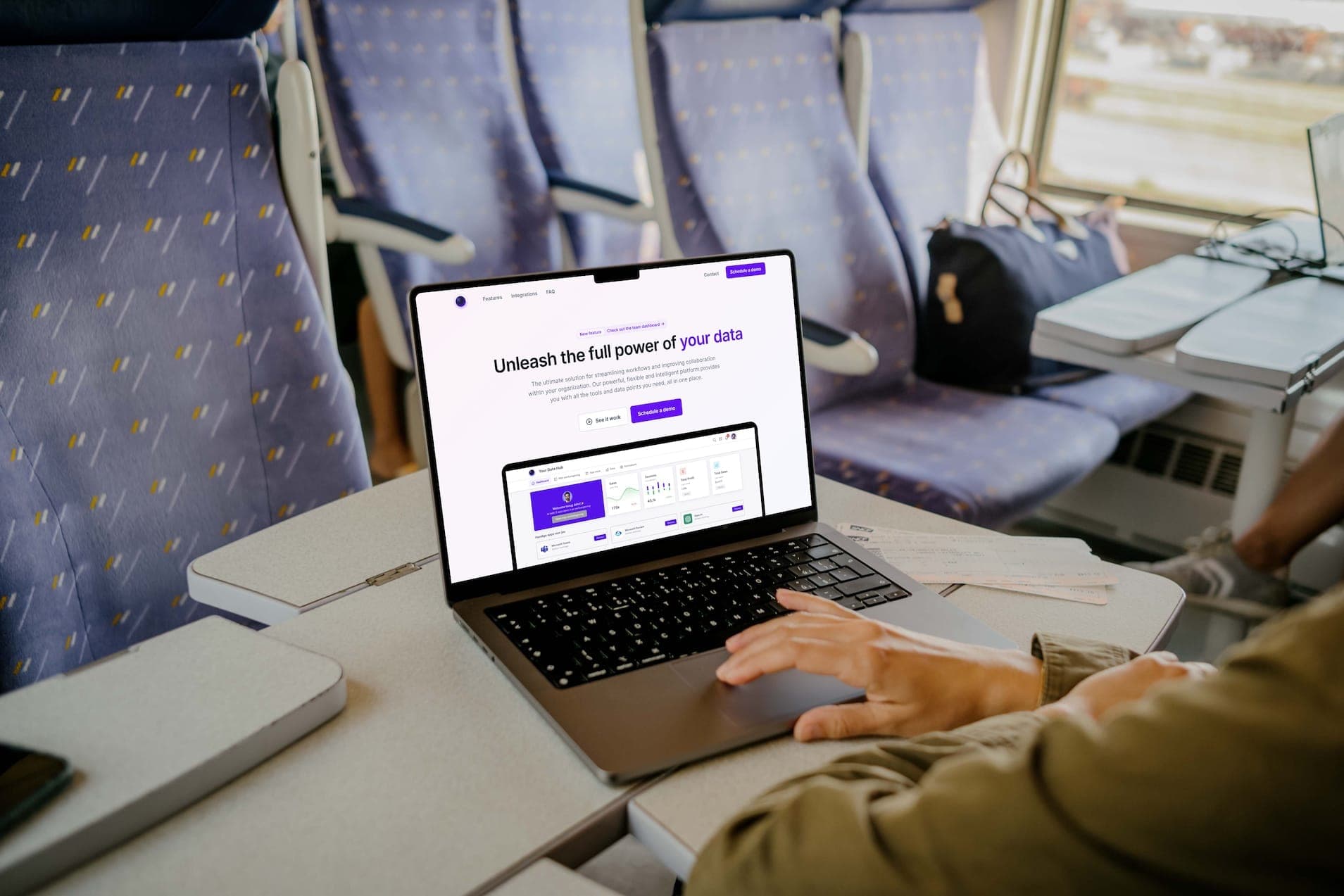 Someone working on a laptop on a train with the data platform's homepage open.