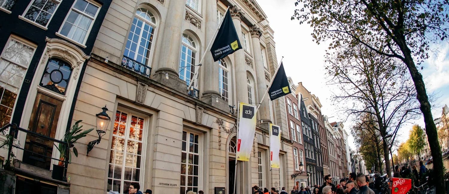 Felix Meritis on the Keizersgracht during ADE, with the festival's flags
