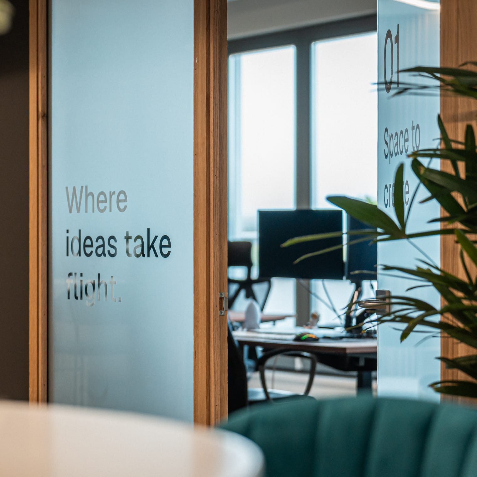 The Your Tech Club office with the 'Where ideas take flight' wall